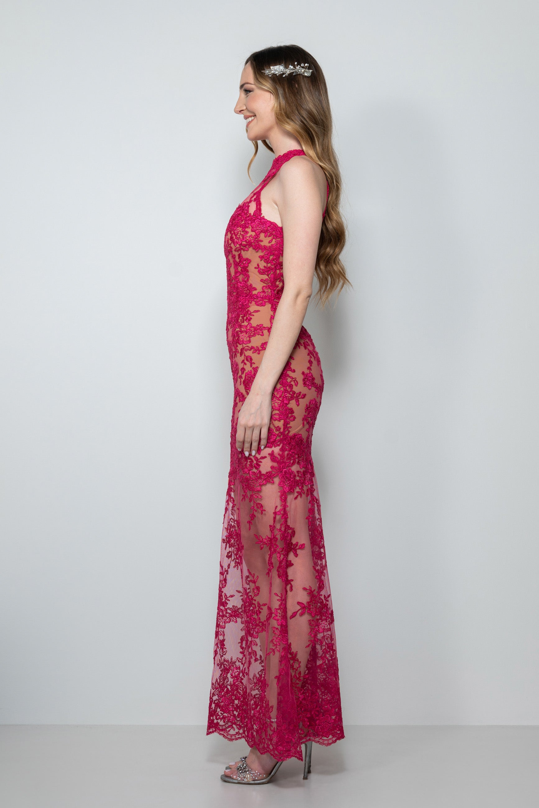 Modella con abito sirena in pizzo rebrodè cremisi, scollo all'americana Vestito 18esimo sirena pizzo rebrodè con fiocco sulla schiena Dettaglio pizzo rebrodè effetto vedo-non-vedo vestito 18esimo a noleggio Abito 18esimo sirena in pizzo rebrodè cremisi con scollo all'americana